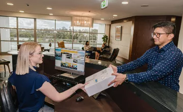 Receptionist helping clients at the front desk
