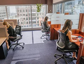 Servcorp clients working in a premium coworking space at 10 Avenue Kléber.