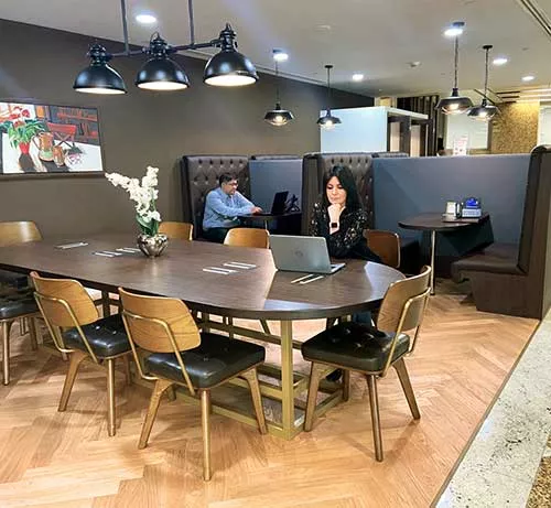 Professionals working within Servcorp’s stylish coworking space. 